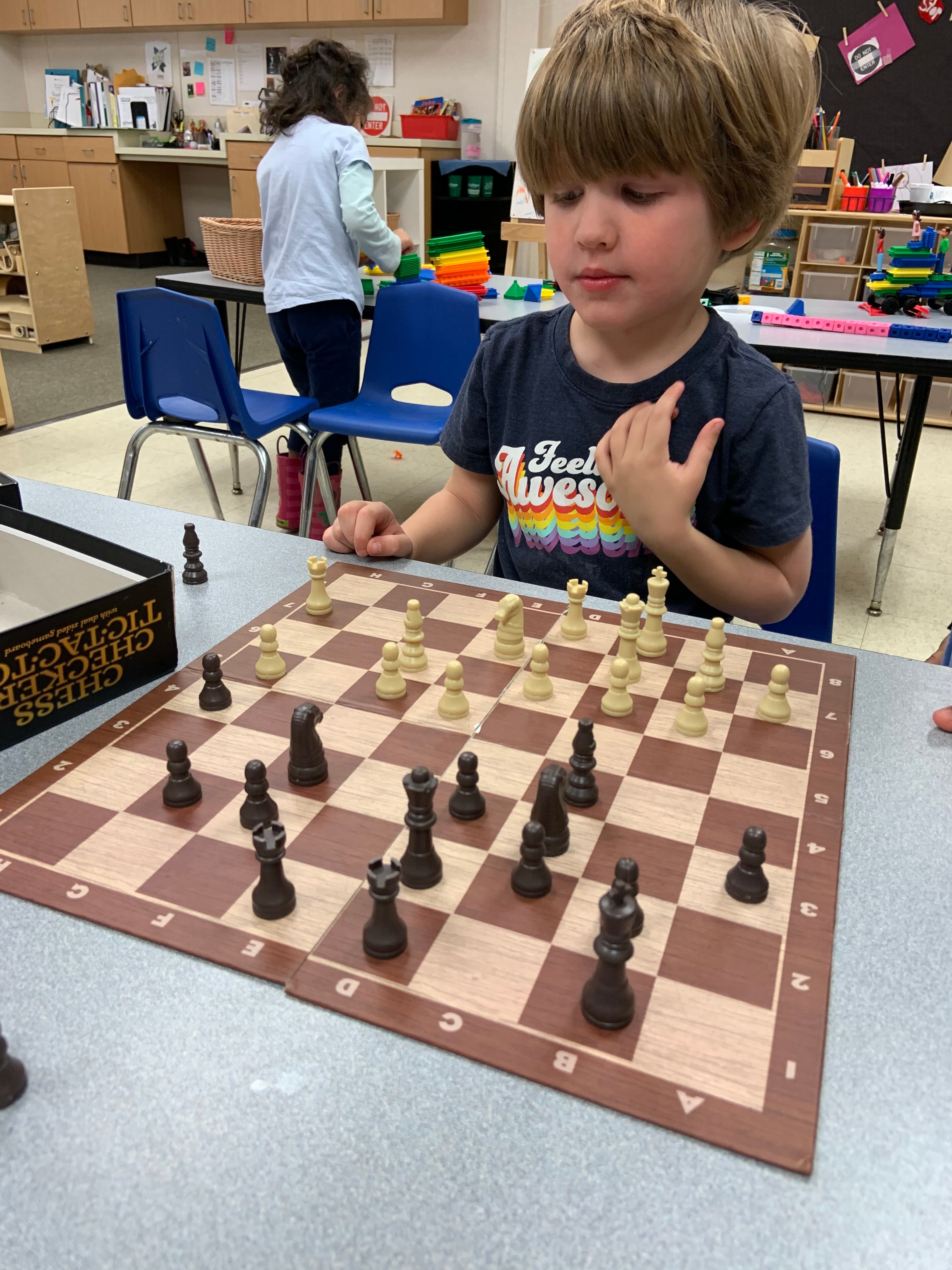 Young student concentrating over a chessboard during a lesson