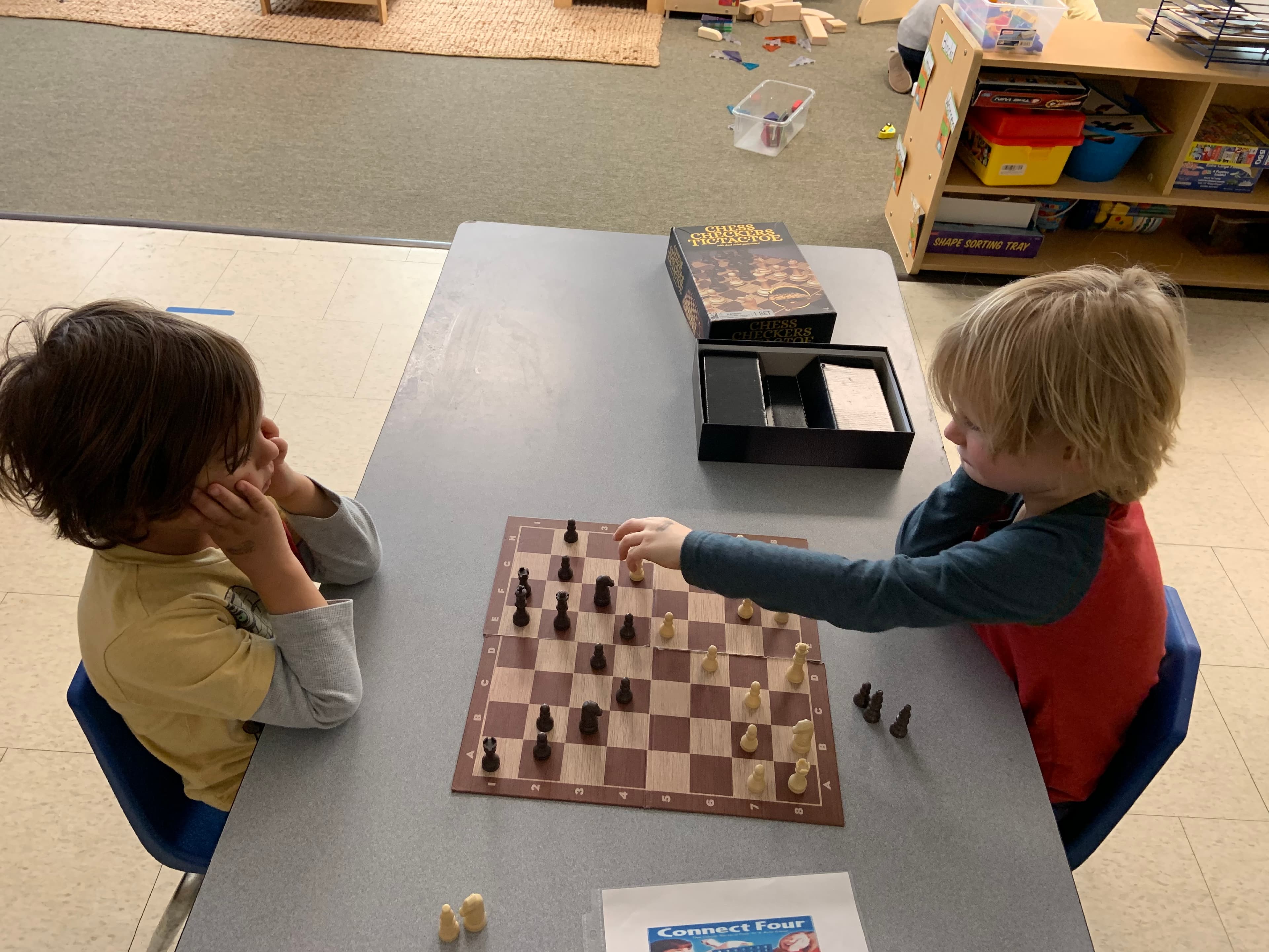Two young students playing chess together