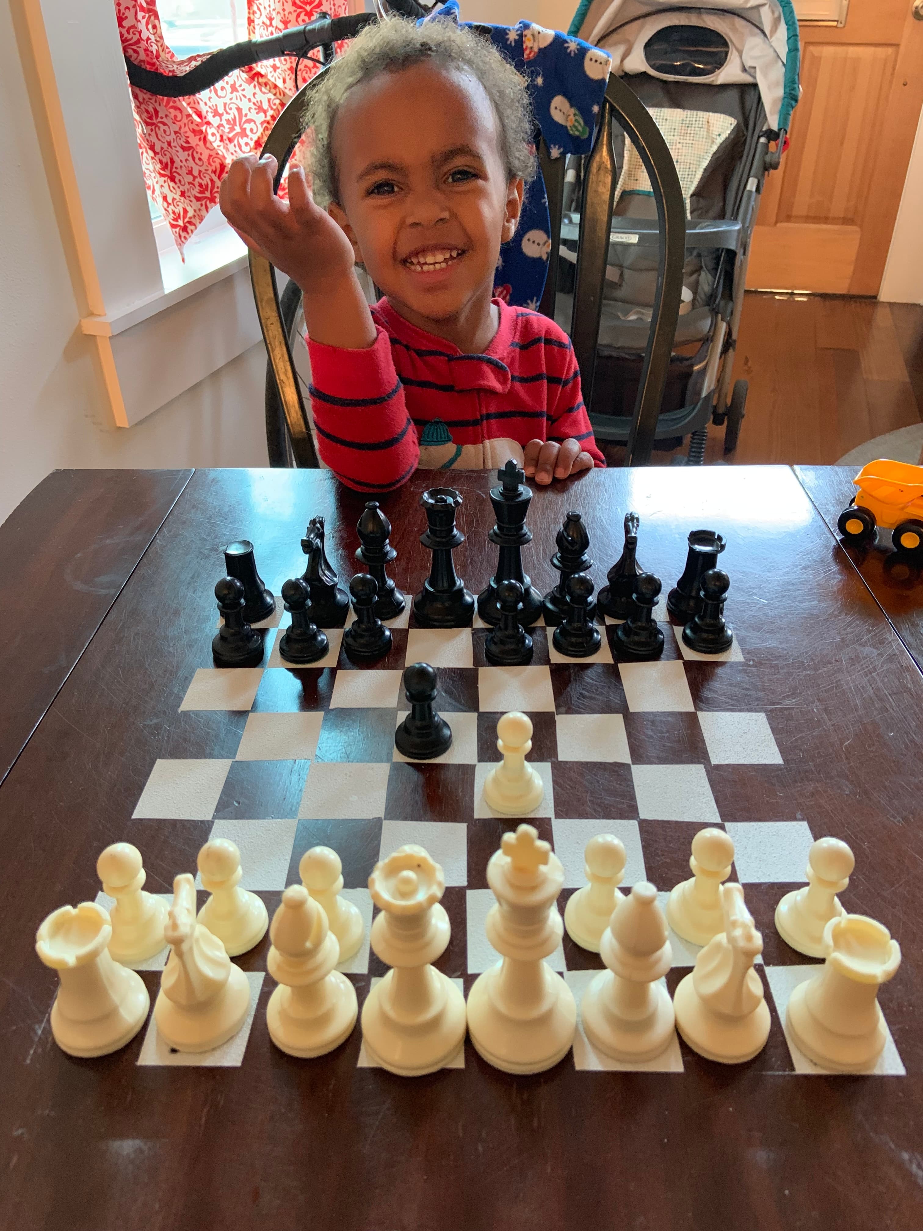 Young student exploring a chess position at home